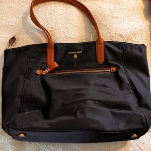 Michael Kors Pocket book with tan shoulder straps. Navy blue